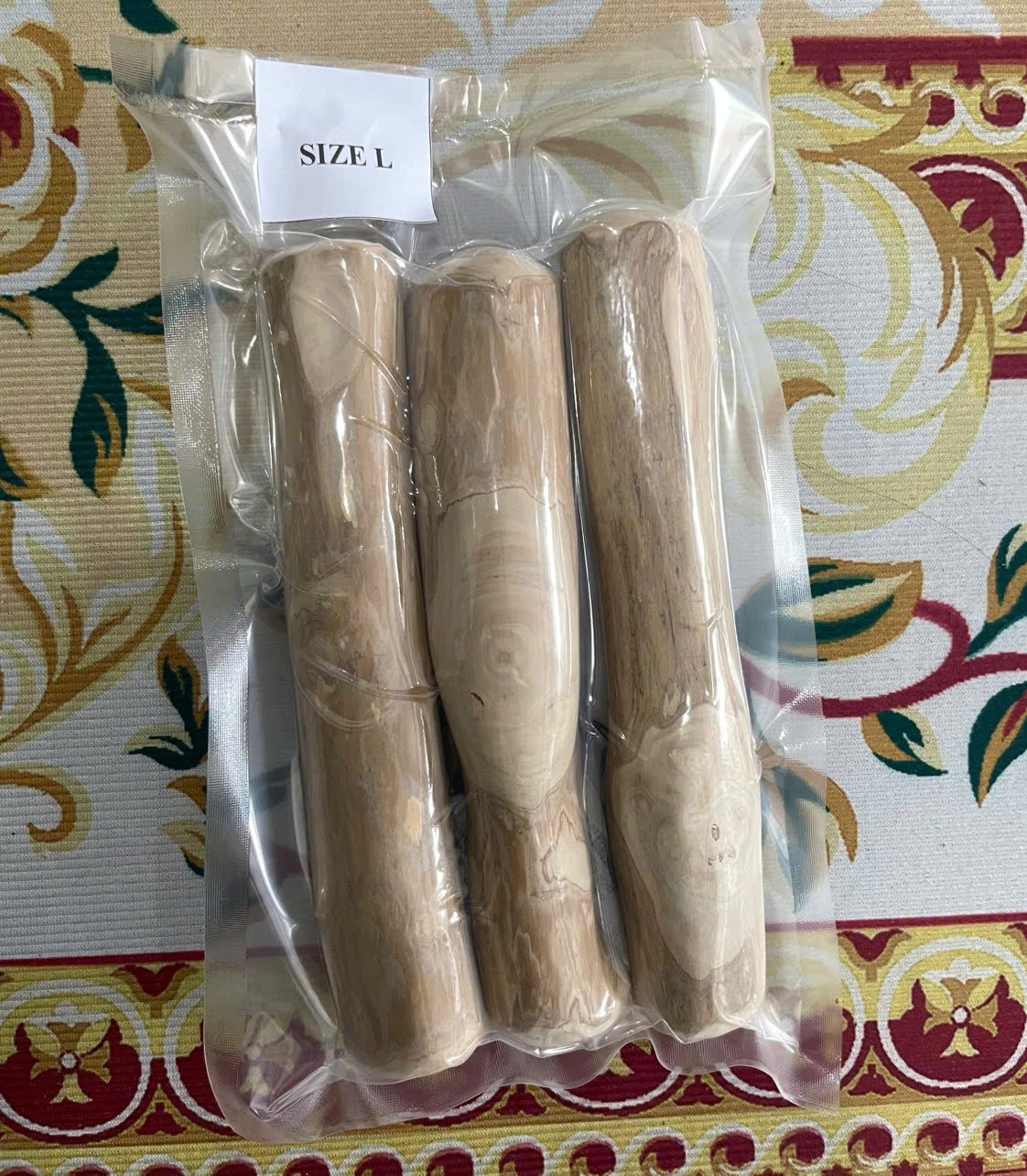 Vacuum-sealed pack of coffee wood dog chews with a size label, ready for Amazon FBA