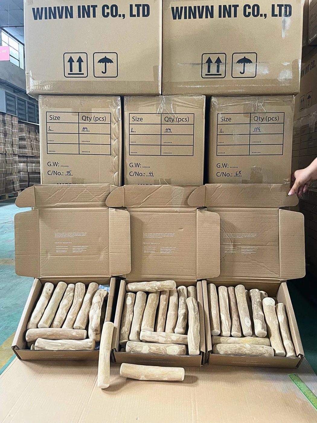Packed cartons of coffee wood dog chews at the WINVN factory, ready to ship