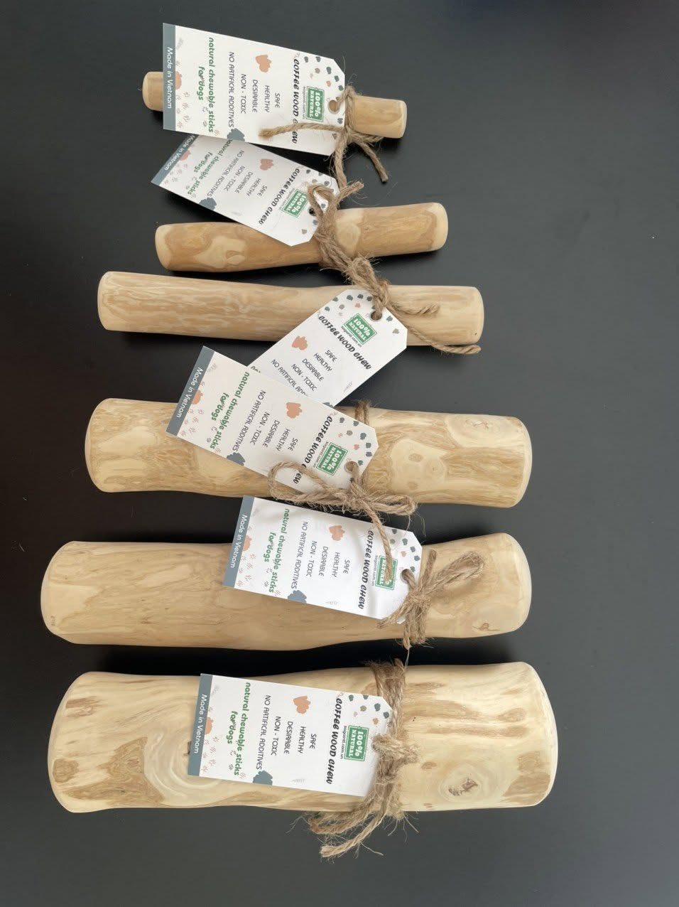 Coffee wood dog chews with custom hang tags for a pet shop brand