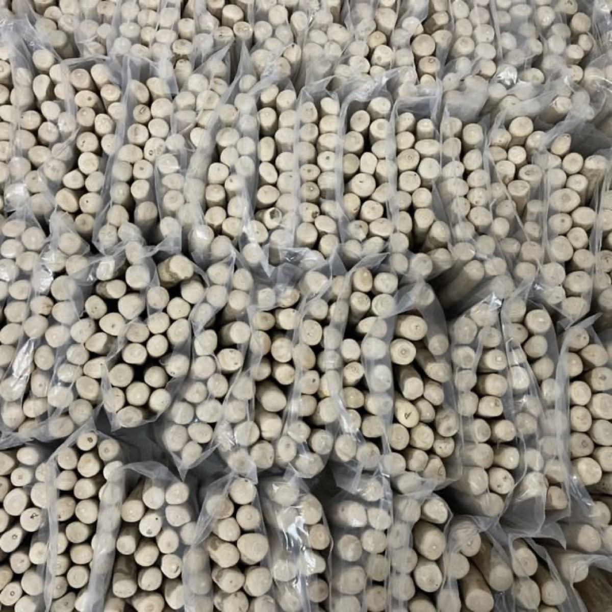 Worker finishing and quality-checking coffee wood chews